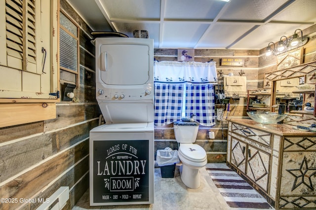 34 Rosebloom Rd, Hadley, NY 12835 - bathroom featuring stacked washer / dryer, toilet, vanity, and wooden walls