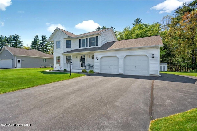 view of front facade featuring covered porch, a garage, asphalt driveway, and a front yard