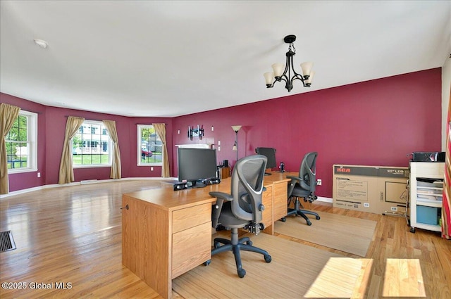office space featuring wood finished floors, a chandelier, and baseboards