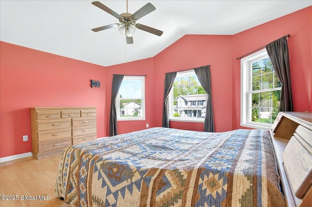 bedroom featuring vaulted ceiling, wood finished floors, ceiling fan, and baseboards