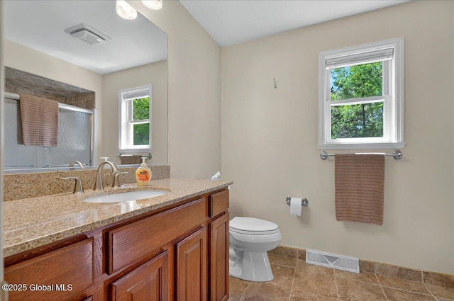 bathroom with a shower with shower door, toilet, baseboards, and vanity