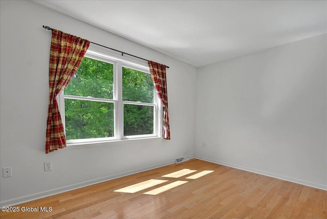 unfurnished room featuring wood finished floors and baseboards