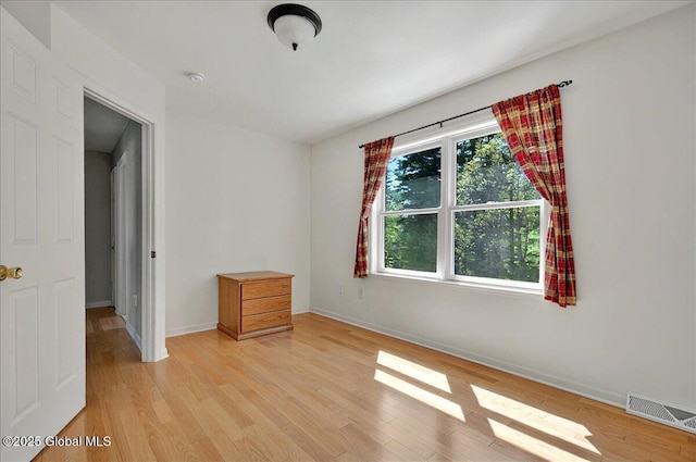 unfurnished bedroom with light wood finished floors and baseboards