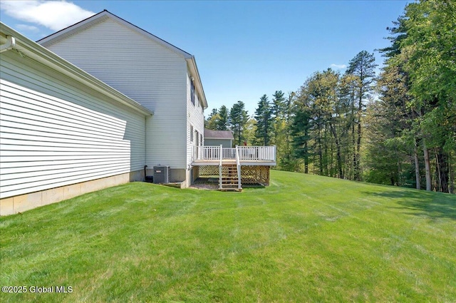 view of green lawn featuring cooling unit and a wooden deck