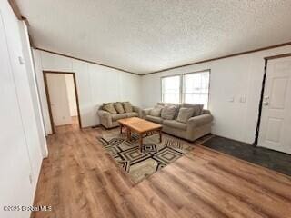 living area featuring wood finished floors and a textured ceiling