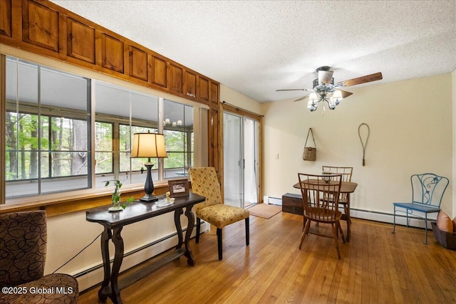 1 High Pines Ter Unit 1C, Chester, NY 12817 - sitting room with baseboard heating, a textured ceiling, light wood-style floors, and ceiling fan