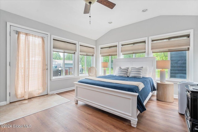 bedroom featuring vaulted ceiling, wood finished floors, ceiling fan, and baseboards