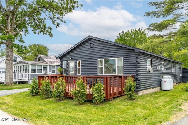 rear view of house featuring log exterior, crawl space, a yard, and a wooden deck
