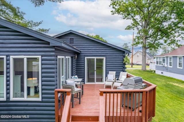 wooden terrace featuring area for grilling and a lawn