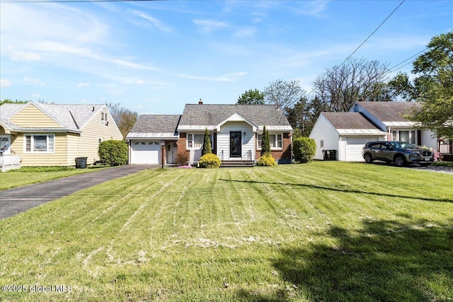 view of front facade featuring driveway, a garage, brick siding, and a front yard