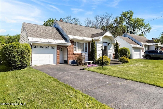 view of front of home featuring an attached garage, brick siding, asphalt driveway, a front lawn, and a shingled roof