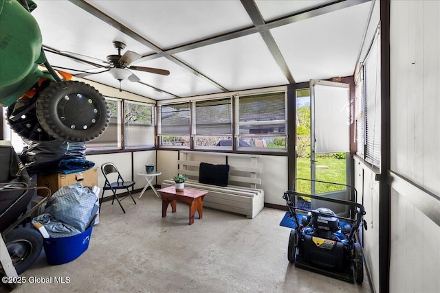 sunroom featuring a ceiling fan, healthy amount of natural light, and vaulted ceiling