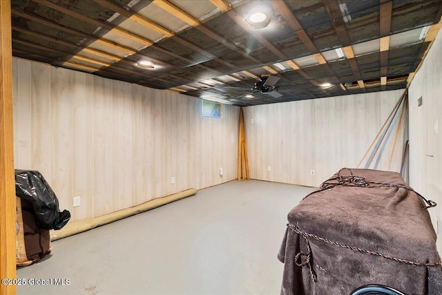 finished basement featuring wood walls
