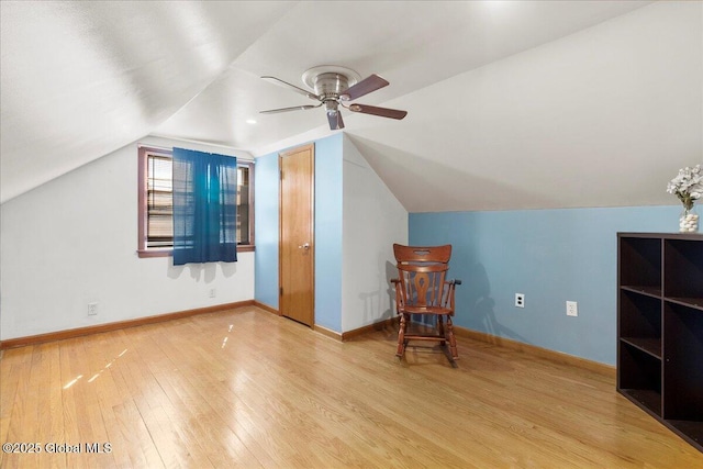 bonus room with wood finished floors, vaulted ceiling, ceiling fan, and baseboards