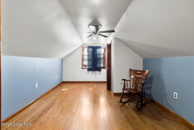 bonus room with wood finished floors, a ceiling fan, baseboards, and lofted ceiling