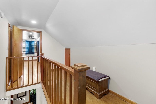 stairs with vaulted ceiling, wood finished floors, ceiling fan, recessed lighting, and baseboards