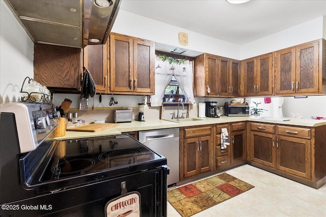 kitchen with a sink, appliances with stainless steel finishes, light countertops, and brown cabinets