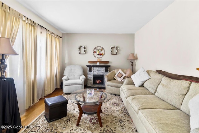 living area featuring light wood-style flooring and a fireplace