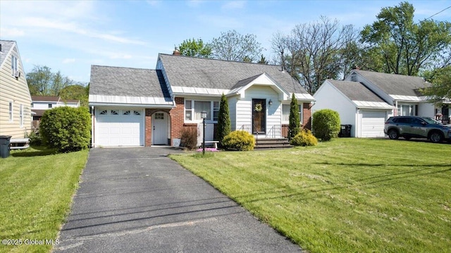 view of front of house featuring an attached garage, brick siding, a front lawn, and asphalt driveway