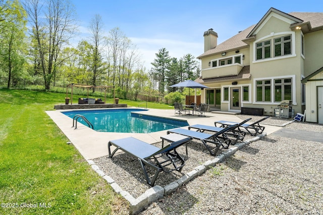 outdoor pool featuring a patio area and grilling area