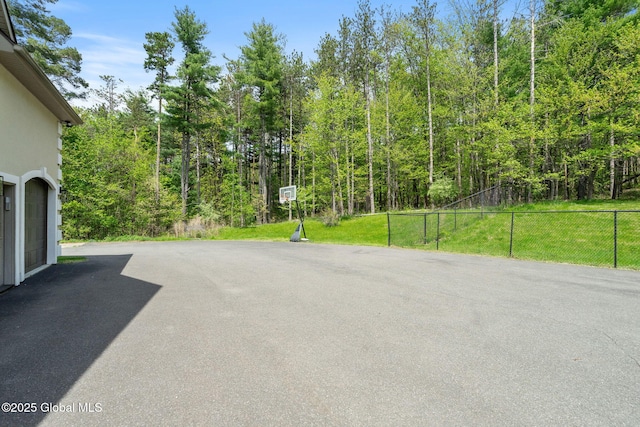 view of road with a wooded view