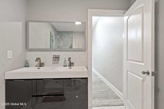 full bathroom with decorative backsplash, double vanity, and baseboards