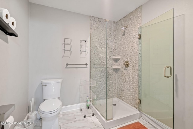 full bathroom with toilet, a stall shower, baseboards, and marble look tiles