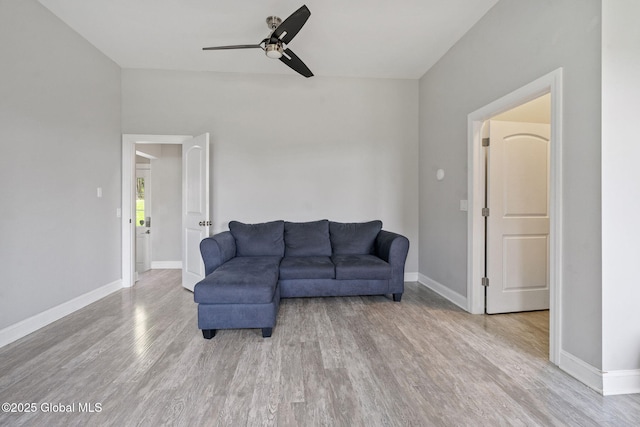 living area with ceiling fan, wood finished floors, and baseboards