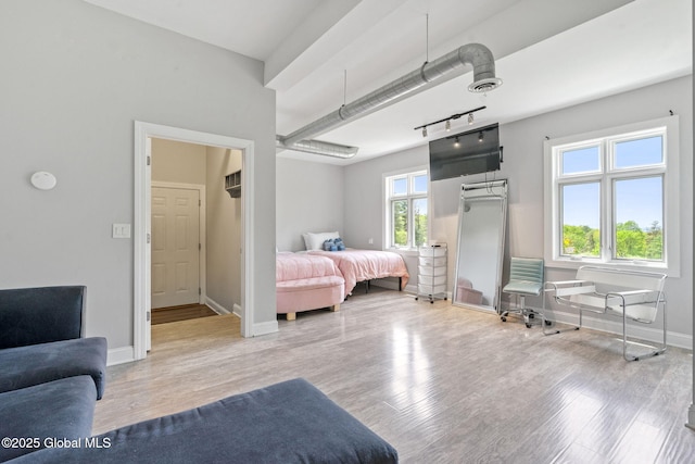 bedroom featuring light wood-style flooring and baseboards