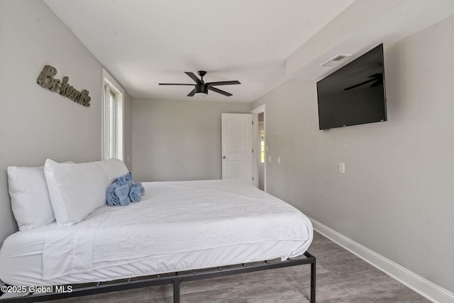 bedroom with baseboards, wood finished floors, and ceiling fan