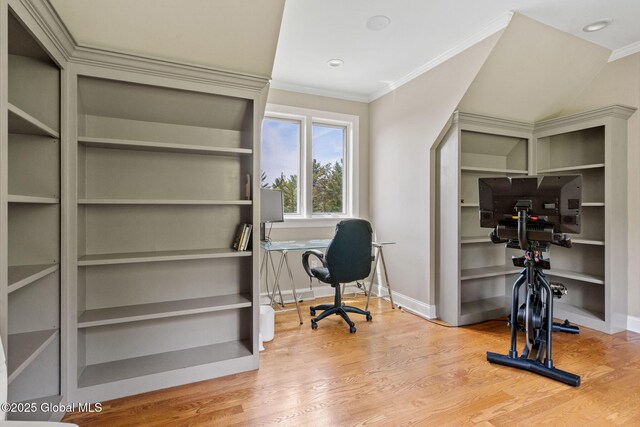 office featuring ornamental molding, wood finished floors, baseboards, and built in shelves