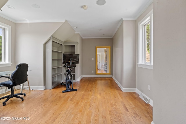 home office with light wood-style floors, baseboards, and ornamental molding