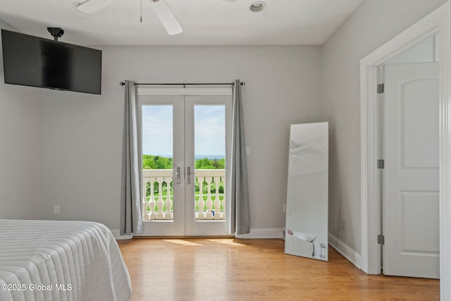 bedroom featuring access to outside, french doors, light wood-style flooring, and ceiling fan