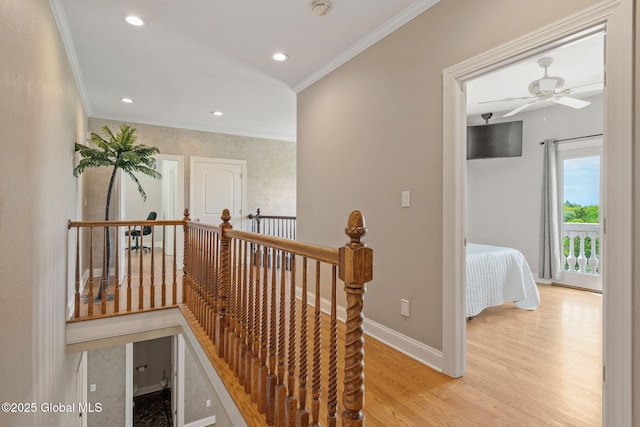 corridor featuring an upstairs landing, crown molding, baseboards, light wood-style floors, and recessed lighting
