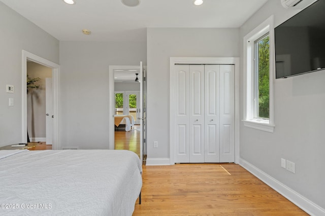 bedroom featuring light wood-style flooring, recessed lighting, a closet, and baseboards