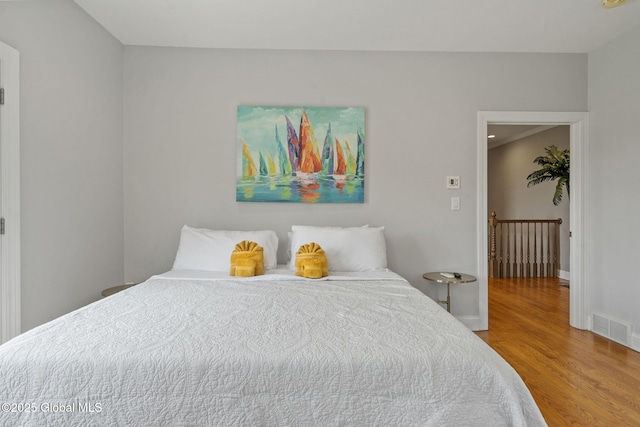 bedroom featuring wood finished floors and baseboards