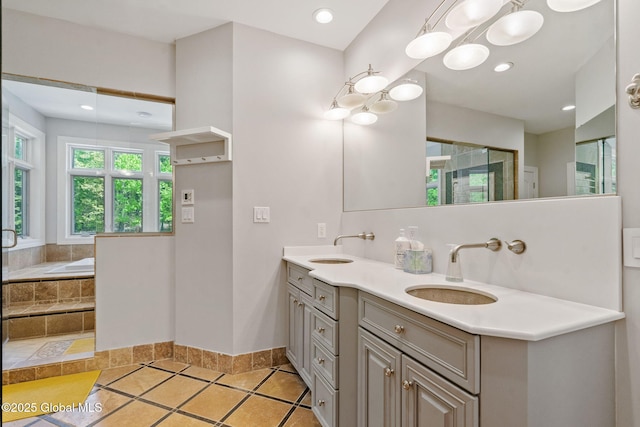 full bath with baseboards, double vanity, a garden tub, a stall shower, and recessed lighting