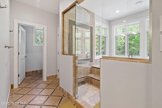 full bath with plenty of natural light, baseboards, a stall shower, and recessed lighting
