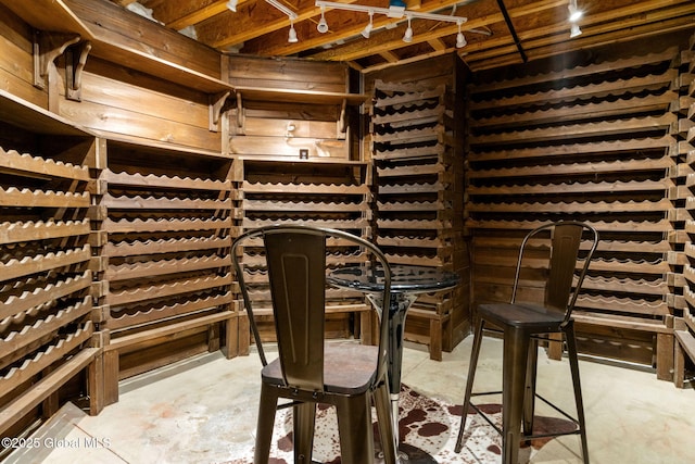 wine room featuring unfinished concrete flooring