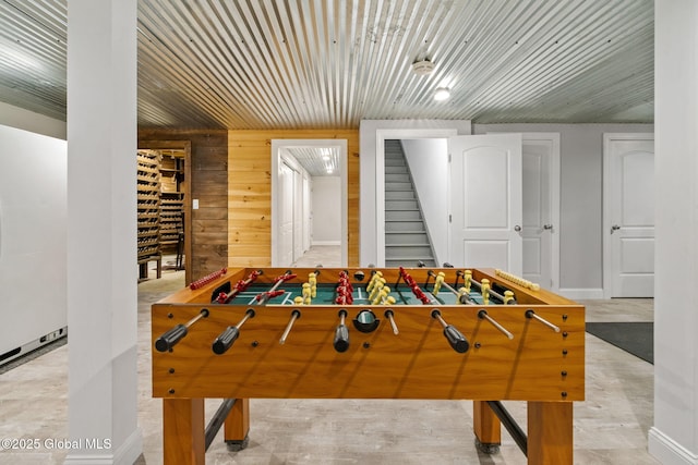 game room with wooden walls and baseboards