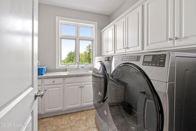 clothes washing area with cabinet space and washer and dryer