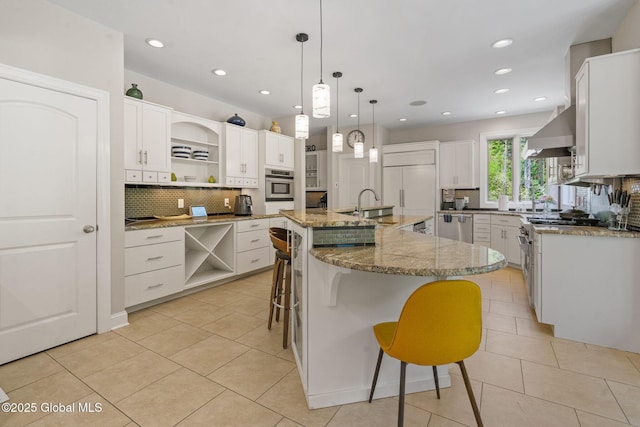kitchen with open shelves, high quality appliances, wall chimney range hood, tasteful backsplash, and recessed lighting