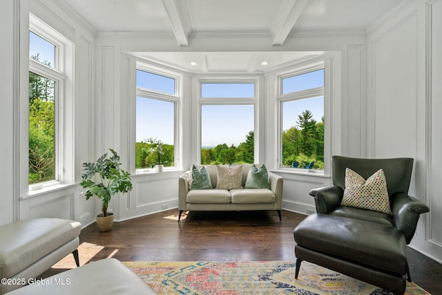 sunroom featuring a decorative wall, plenty of natural light, crown molding, beam ceiling, and wood finished floors