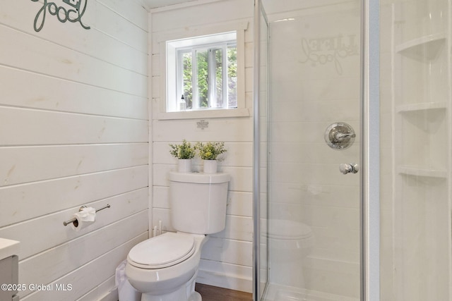 full bathroom featuring toilet and a stall shower