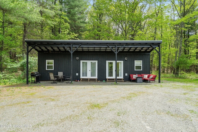 rear view of property with an outdoor hangout area, french doors, and entry steps