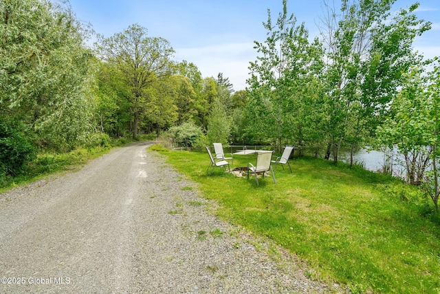 view of dirt / gravel road with a water view