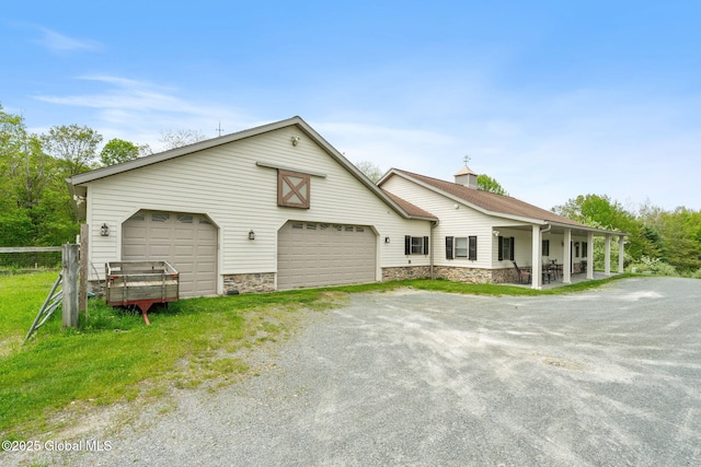 view of front of home with stone siding and a garage