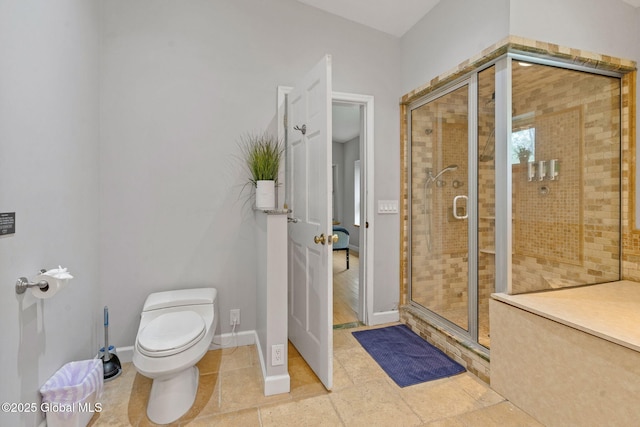 full bath featuring a stall shower, toilet, and baseboards