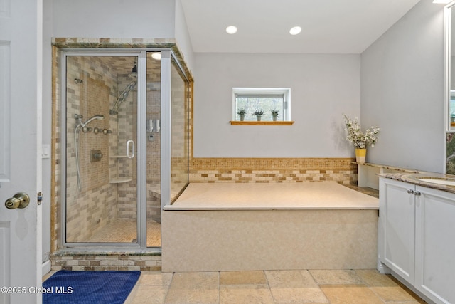 full bathroom with a shower stall, vanity, and recessed lighting