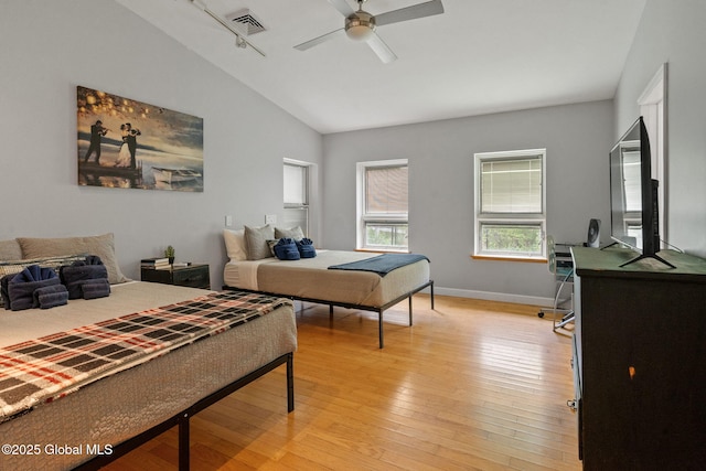 bedroom with lofted ceiling, light wood-style flooring, baseboards, and ceiling fan